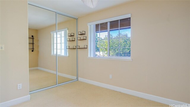 unfurnished bedroom with carpet floors and a closet