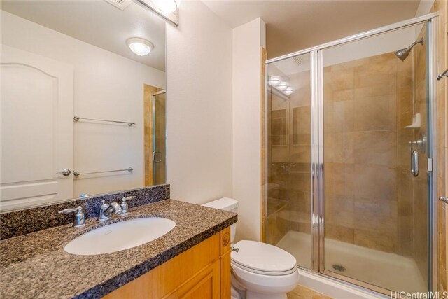 bathroom featuring vanity, toilet, and walk in shower