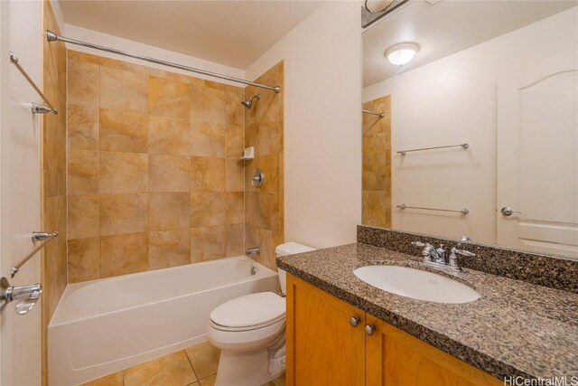 full bathroom featuring tile patterned flooring, vanity, toilet, and tiled shower / bath