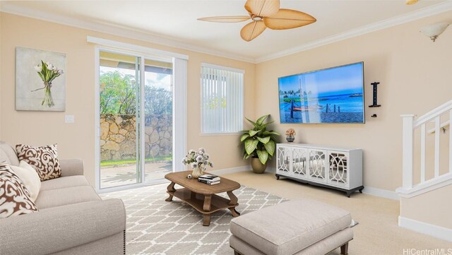 carpeted living room with ceiling fan and ornamental molding