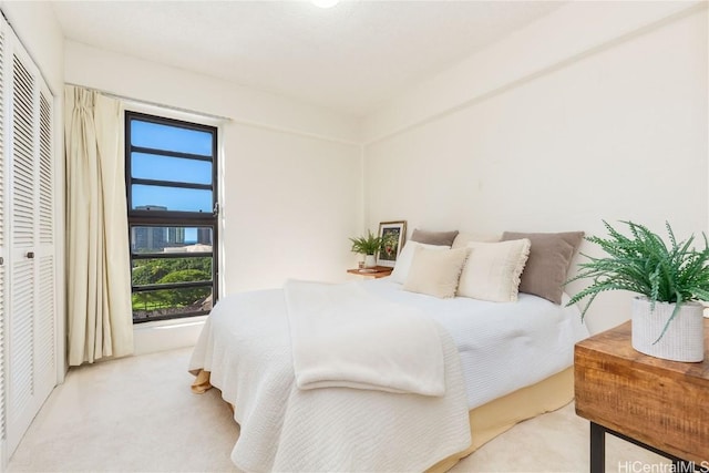 bedroom featuring light carpet and a closet