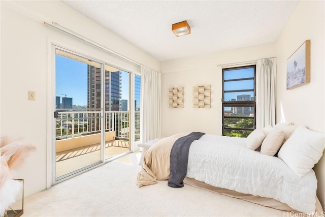 bedroom featuring access to exterior, carpet flooring, and multiple windows