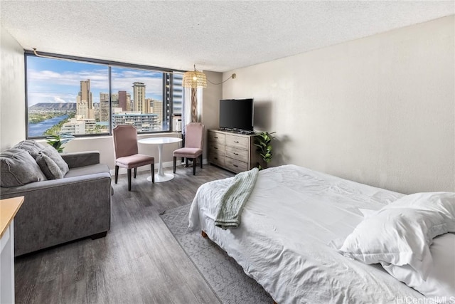 bedroom with a textured ceiling and dark wood-type flooring