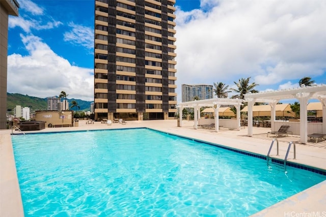 view of swimming pool with a patio area and a pergola