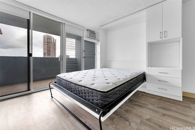 bedroom with a textured ceiling and dark wood-type flooring