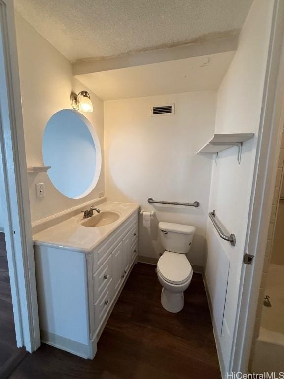 full bathroom featuring separate shower and tub, a textured ceiling, toilet, vanity, and hardwood / wood-style flooring