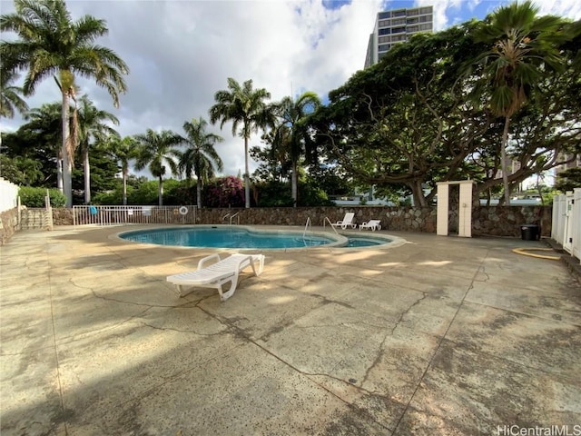 view of swimming pool featuring a patio area