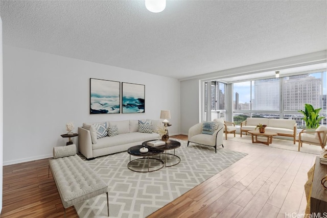 living room with hardwood / wood-style floors and a textured ceiling