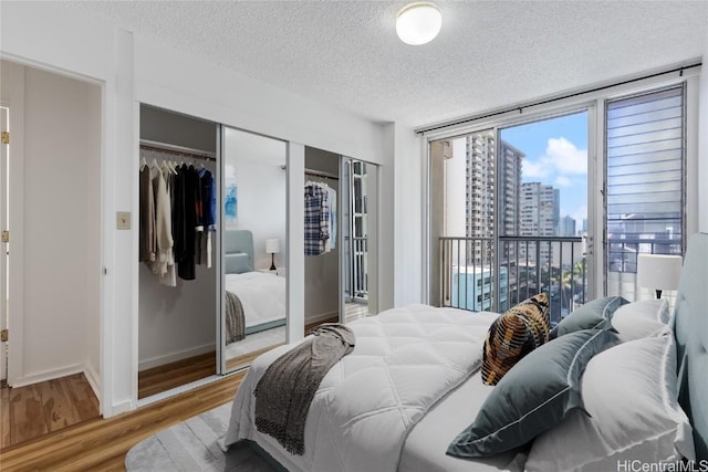 bedroom with hardwood / wood-style flooring and a textured ceiling