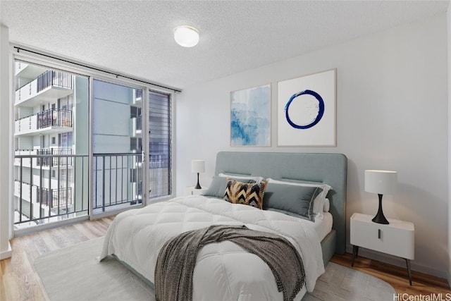 bedroom featuring hardwood / wood-style floors and a textured ceiling