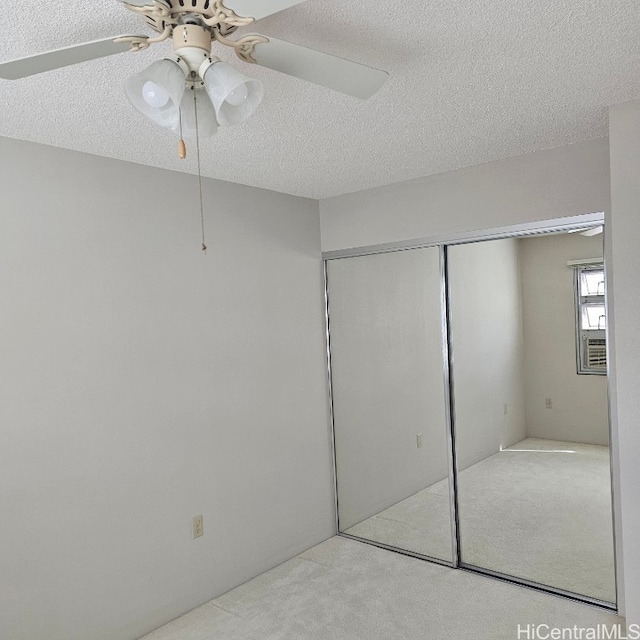 unfurnished bedroom featuring a closet, ceiling fan, and a textured ceiling