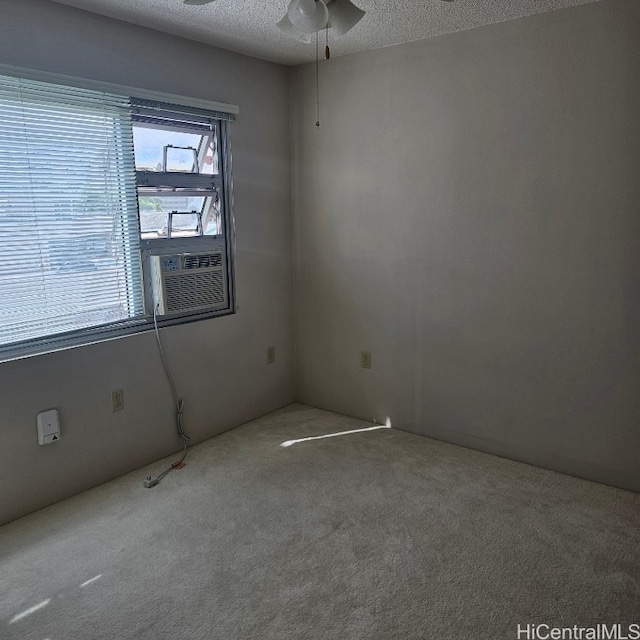 unfurnished room featuring ceiling fan, a textured ceiling, and carpet