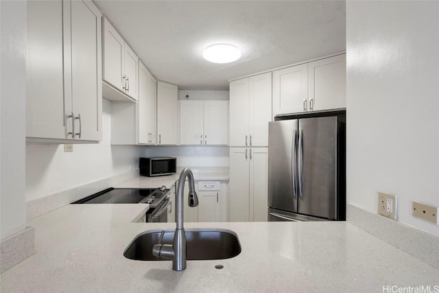 kitchen with sink, white cabinets, and stainless steel appliances