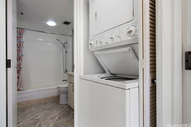 clothes washing area with stacked washer / drying machine