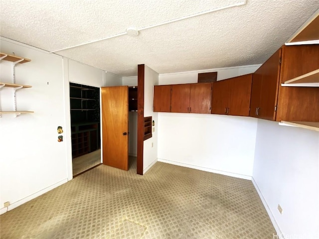 carpeted spare room featuring a textured ceiling