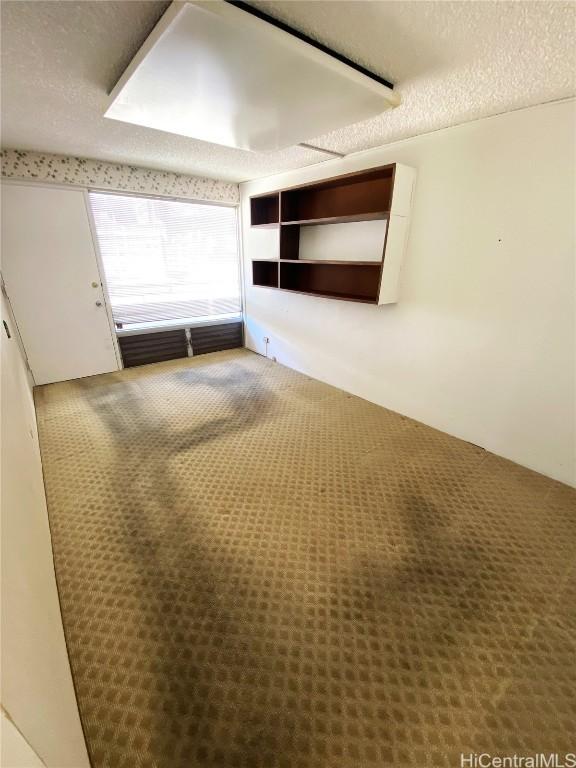 unfurnished room featuring a textured ceiling