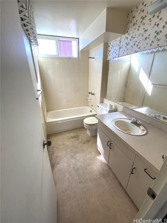 full bathroom featuring vanity, toilet, and tiled shower / bath