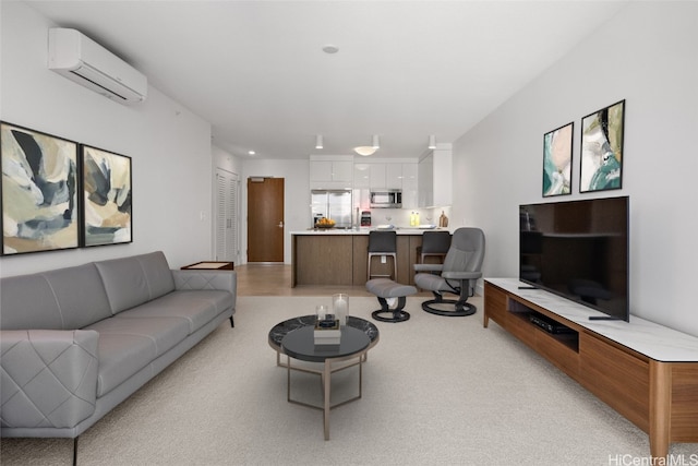 living room with a wall mounted AC and light colored carpet