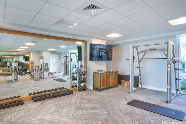 gym featuring carpet flooring and a drop ceiling