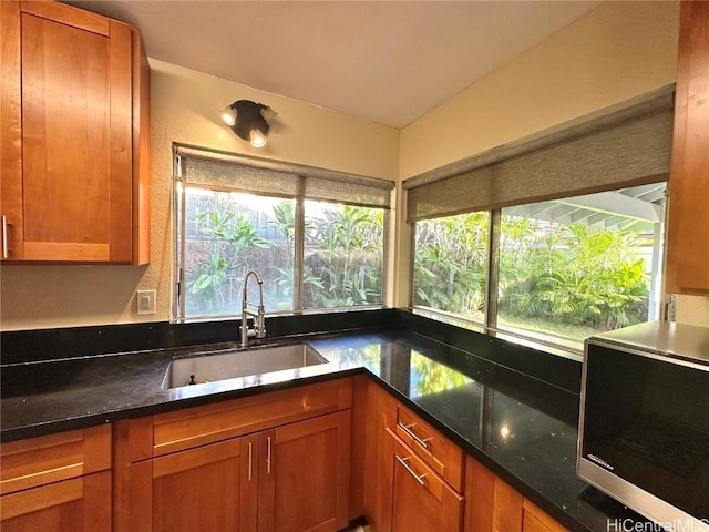 kitchen featuring sink and dark stone counters