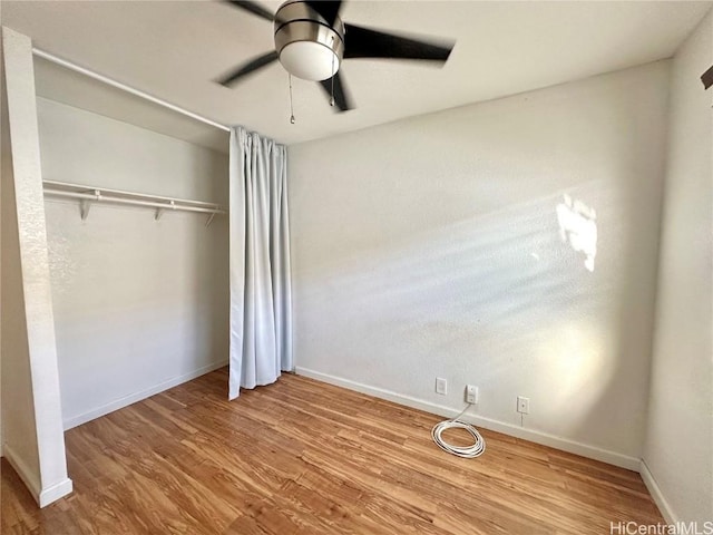 unfurnished bedroom with ceiling fan, a closet, and light hardwood / wood-style flooring