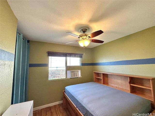 bedroom with ceiling fan, cooling unit, a textured ceiling, and hardwood / wood-style flooring