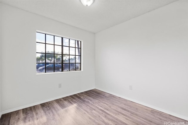 empty room featuring hardwood / wood-style floors and a textured ceiling