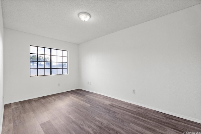 91-1022 Kaiau Ave Unit 3B, Kapolei, HI 96707 - empty room with dark wood-style floors and a textured ceiling