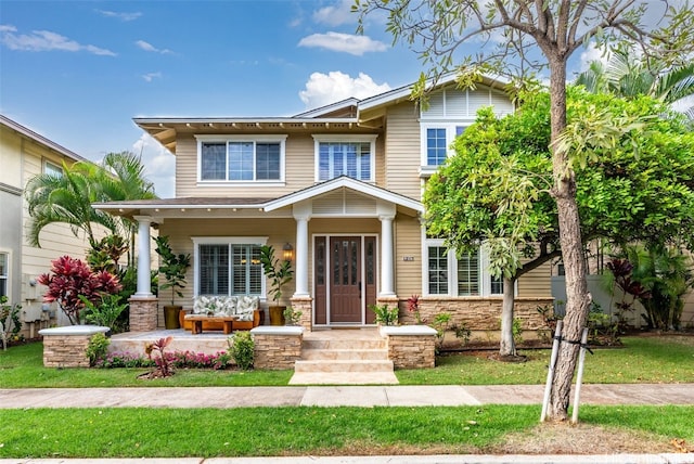 craftsman house with stone siding and a porch