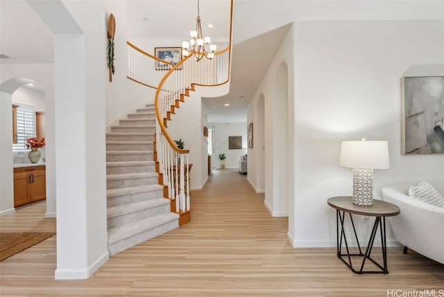 entrance foyer featuring stairs, recessed lighting, baseboards, and light wood-style floors