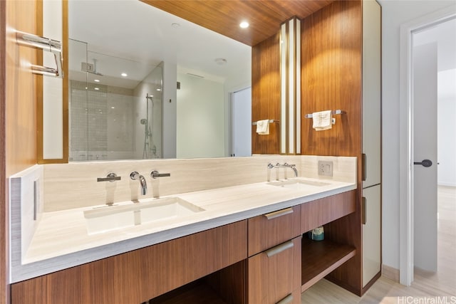 bathroom with walk in shower, vanity, and tasteful backsplash