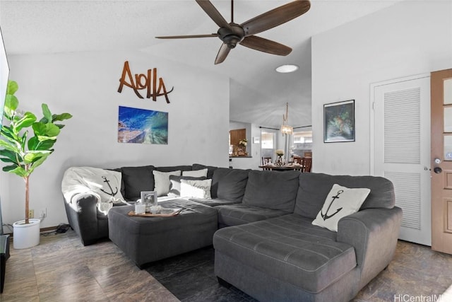 living room featuring ceiling fan and lofted ceiling