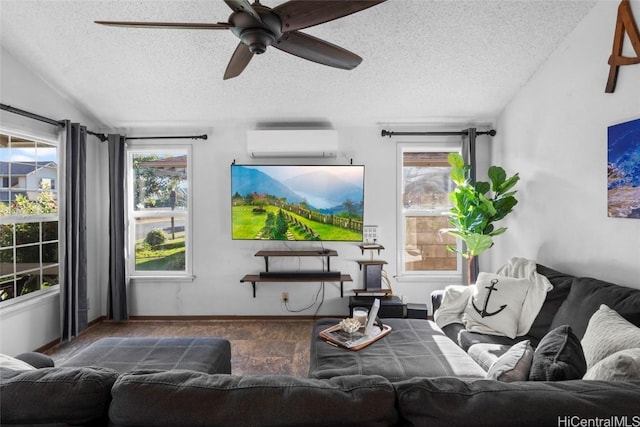 living room with plenty of natural light, a textured ceiling, and a wall mounted AC