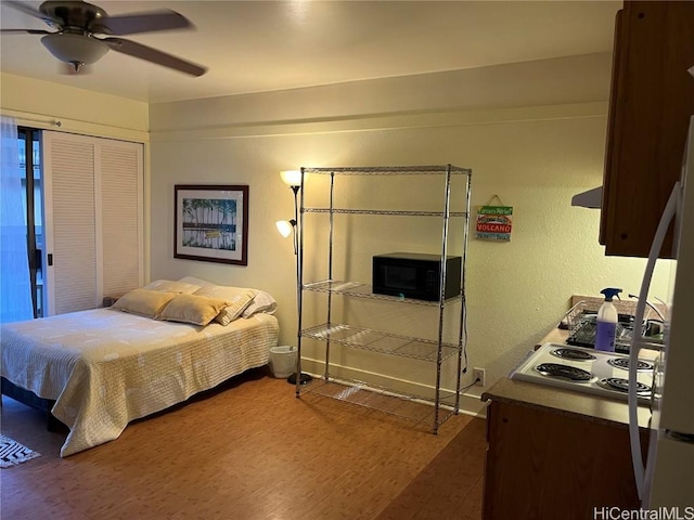 bedroom with wood-type flooring and ceiling fan