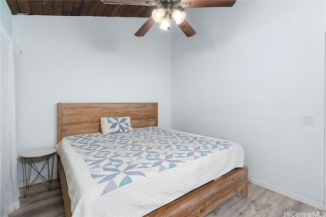 bedroom featuring hardwood / wood-style floors, ceiling fan, and wood ceiling