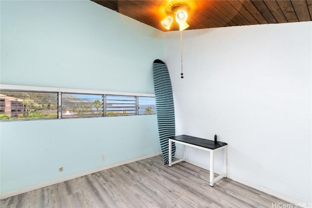 spare room with wooden ceiling, light hardwood / wood-style flooring, and vaulted ceiling