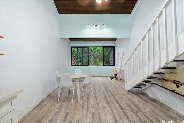 dining space featuring light hardwood / wood-style floors and wood ceiling