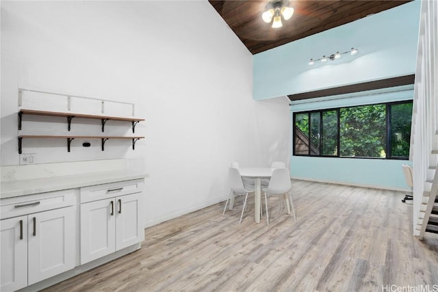 unfurnished dining area with wooden ceiling, light hardwood / wood-style floors, and vaulted ceiling