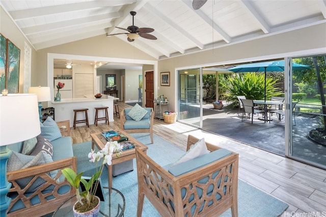 sunroom featuring vaulted ceiling with beams and ceiling fan