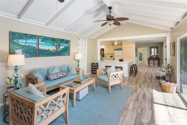 living room featuring vaulted ceiling with beams, light hardwood / wood-style floors, and ceiling fan