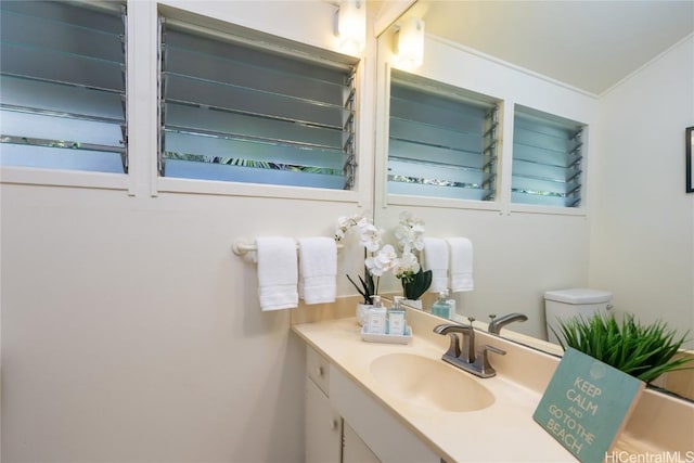 bathroom with vanity and ornamental molding