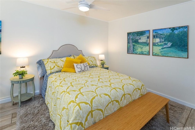 bedroom with ceiling fan and wood-type flooring