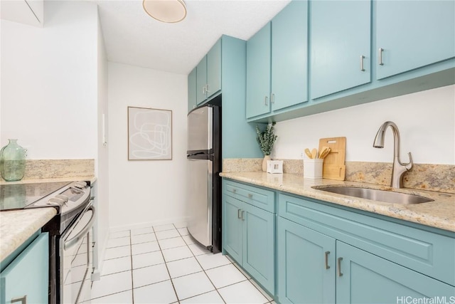 kitchen featuring blue cabinetry, sink, light tile patterned floors, and appliances with stainless steel finishes