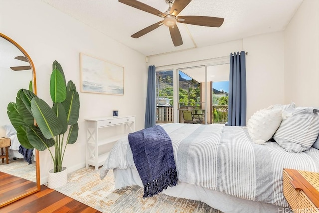 bedroom featuring access to exterior, ceiling fan, and wood-type flooring