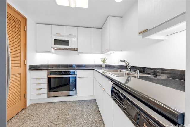 kitchen with white cabinets, appliances with stainless steel finishes, and sink