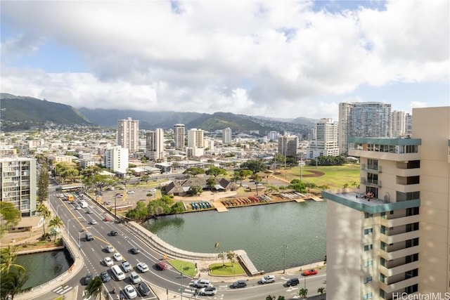 property's view of city with a water and mountain view