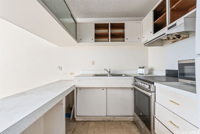 kitchen featuring sink, a textured ceiling, appliances with stainless steel finishes, light tile patterned flooring, and white cabinetry