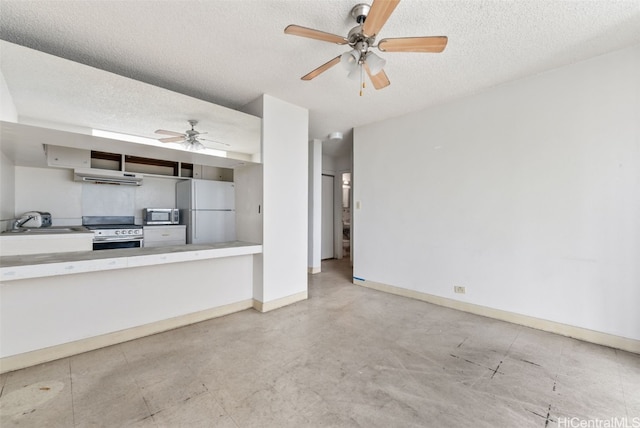 interior space with ceiling fan, sink, and a textured ceiling