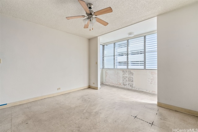 spare room featuring a textured ceiling and ceiling fan