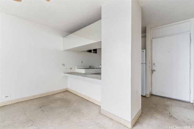 bathroom featuring sink and a textured ceiling